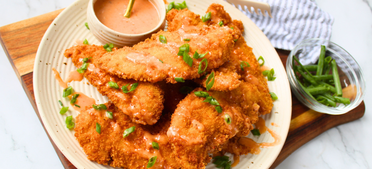 Crunchy bang bang chicken tenders drizzled with creamy spicy sauce — an easy fried chicken recipe perfect for family dinner or game day appetizer.