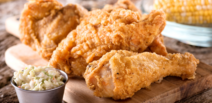 Juicy buttermilk fried chicken with crispy golden crust, served with fresh coleslaw and corn on the cob for a classic Southern comfort meal.
