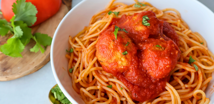 Italian-style ground chicken meatballs served over spaghetti with classic tomato sauce and fresh herbs.