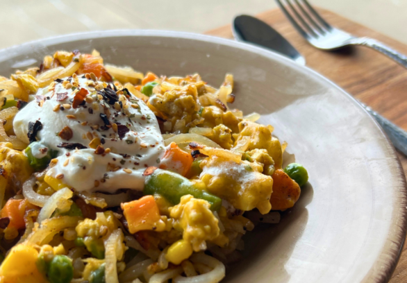 Loaded ground chicken hashbrowns with mixed vegetables, melted cheese, and a dollop of sour cream.