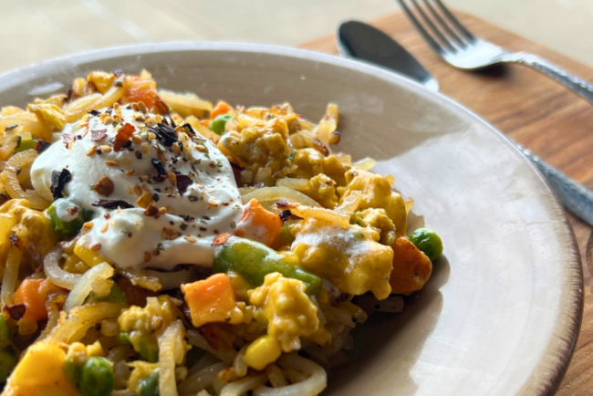 Loaded ground chicken hashbrowns with mixed vegetables, melted cheese, and a dollop of sour cream.