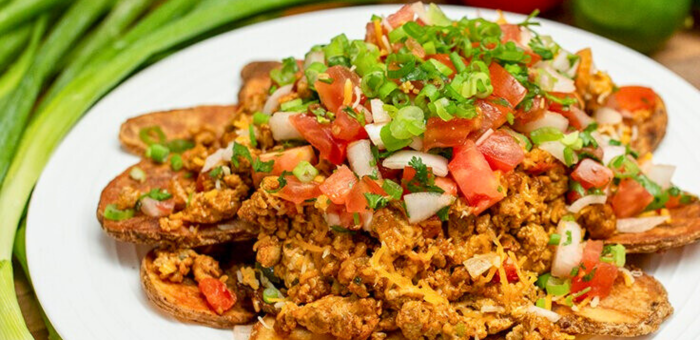 Irish pub–style potato nachos topped with seasoned ground chicken, fresh tomatoes, onions, and green onions.