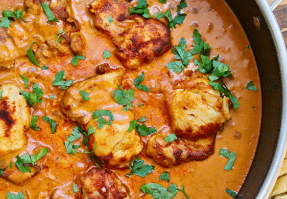 One Skillet Hungarian Chicken Paprikash simmering in a rich, creamy paprika sauce with tender, golden-browned chicken thighs, garnished with fresh parsley and served with slices of crusty bread — an easy, comforting, and authentic Hungarian-inspired chicken dinner.
