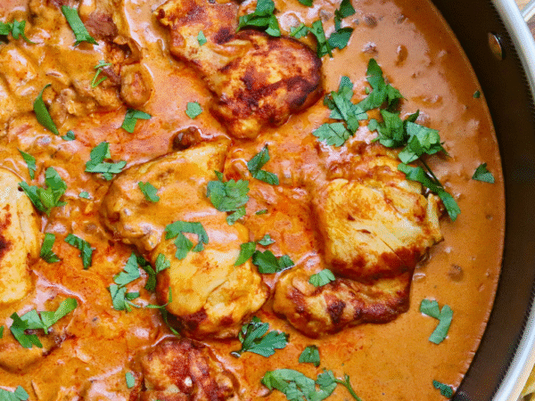 One Skillet Hungarian Chicken Paprikash simmering in a rich, creamy paprika sauce with tender, golden-browned chicken thighs, garnished with fresh parsley and served with slices of crusty bread — an easy, comforting, and authentic Hungarian-inspired chicken dinner.