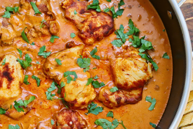One Skillet Hungarian Chicken Paprikash simmering in a rich, creamy paprika sauce with tender, golden-browned chicken thighs, garnished with fresh parsley and served with slices of crusty bread — an easy, comforting, and authentic Hungarian-inspired chicken dinner.