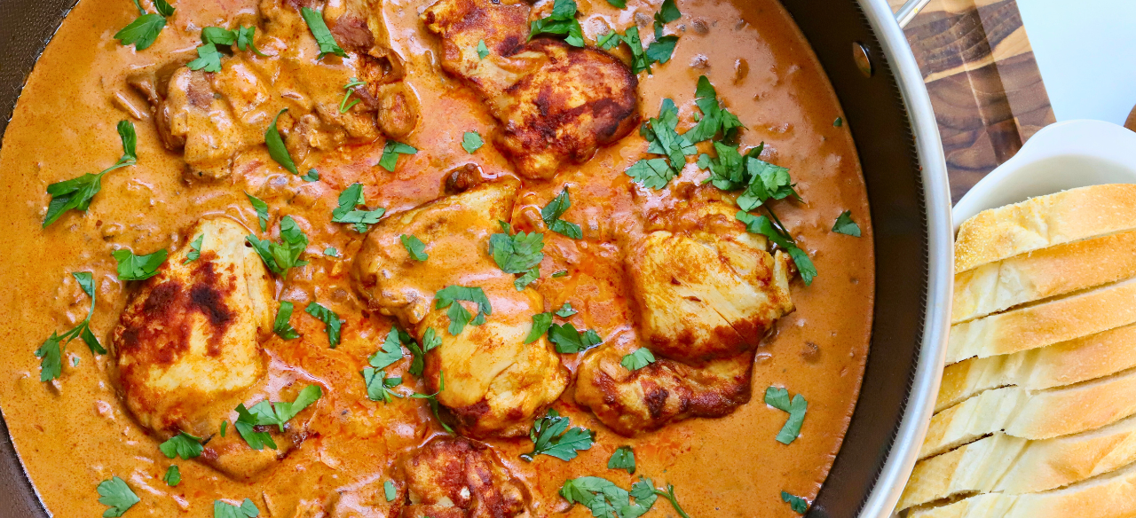 One Skillet Hungarian Chicken Paprikash simmering in a rich, creamy paprika sauce with tender, golden-browned chicken thighs, garnished with fresh parsley and served with slices of crusty bread — an easy, comforting, and authentic Hungarian-inspired chicken dinner.