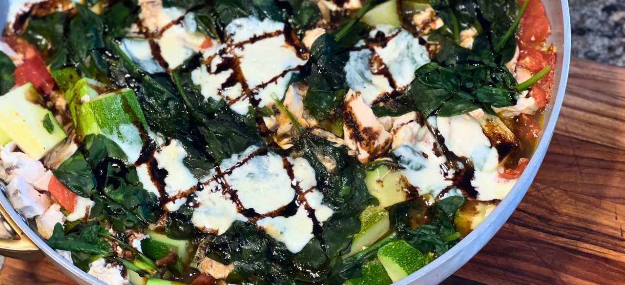 Rustic Tuscan chicken skillet made with Springer Mountain Farms poached chicken thighs, tomatoes, zucchini, baby spinach, fresh mozzarella, and drizzled with balsamic glaze.”