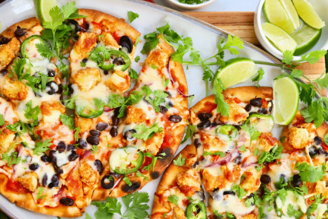 Easy Santa Fe chicken flatbread pizza recipe topped with black beans, jalapeños, melted cheese, and fresh cilantro — a quick and flavorful weeknight dinner.