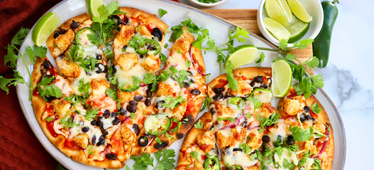 Easy Santa Fe chicken flatbread pizza recipe topped with black beans, jalapeños, melted cheese, and fresh cilantro — a quick and flavorful weeknight dinner.