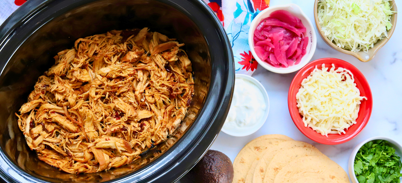 Slow cooker honey chipotle shredded chicken with taco toppings and corn tortillas – spicy chicken meal prep tacos