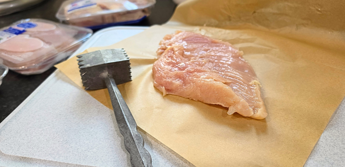 Pounding chicken breast to even thickness before grilling